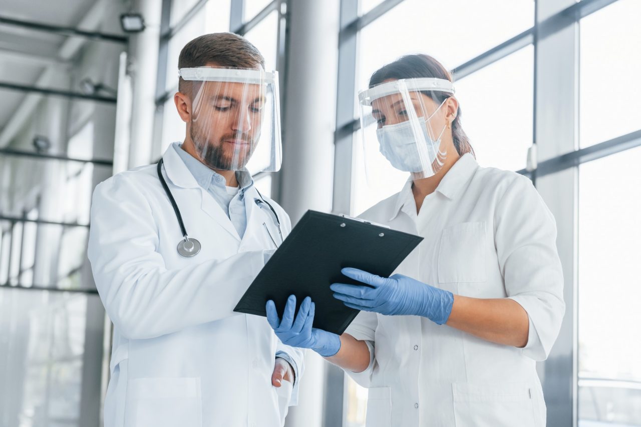 working-with-documents-two-doctors-in-white-coats-is-in-the-clinic.jpg